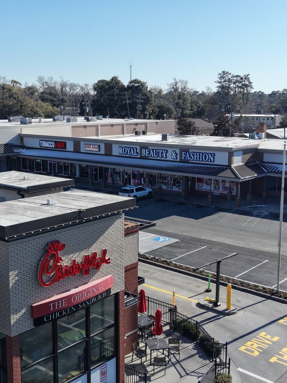 Drone view of Royal Beauty and Fashion behind Chick-fil-A on Victory Drive
