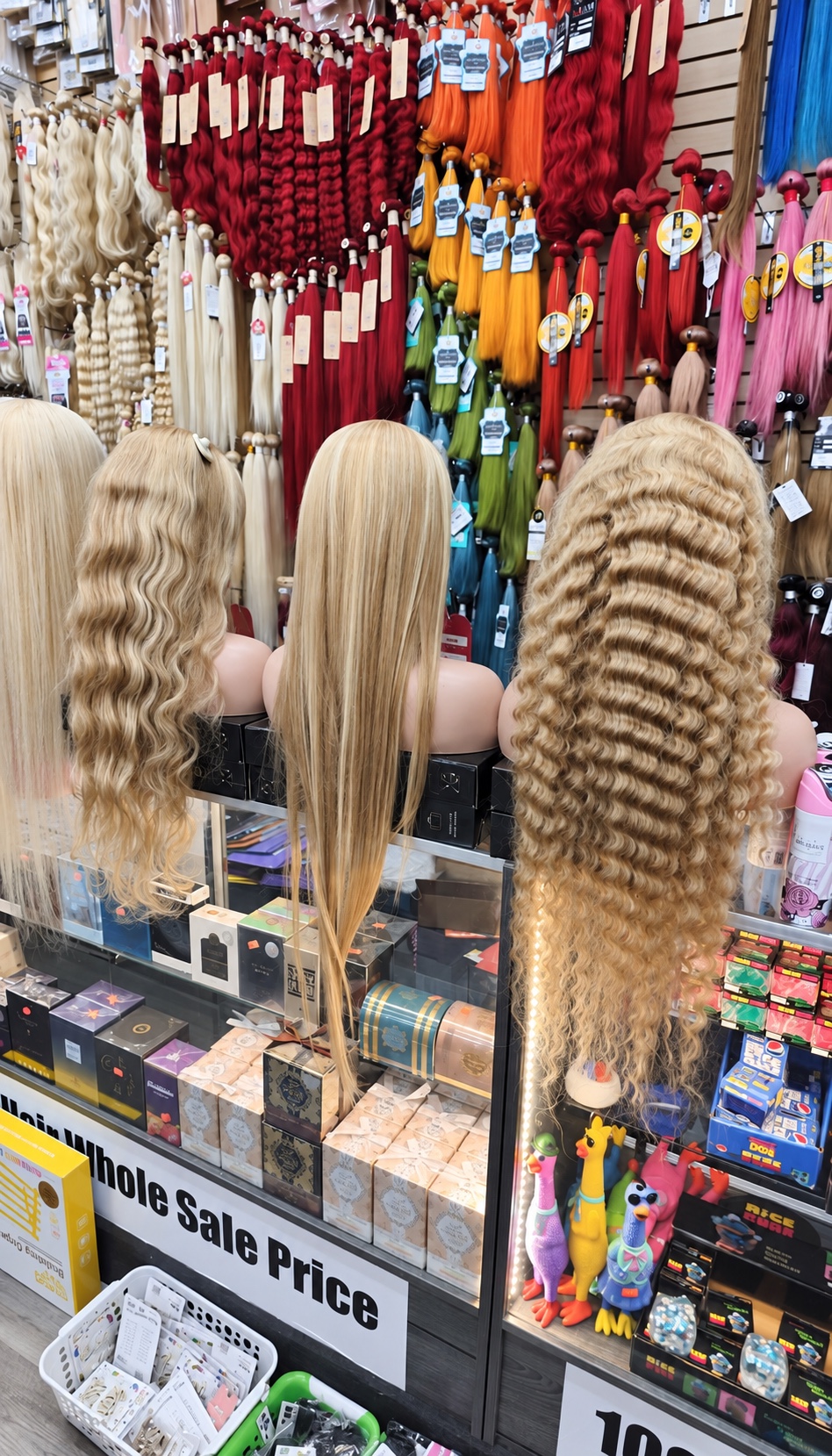 Straight and wavy blonde wigs displayed at Royal Beauty